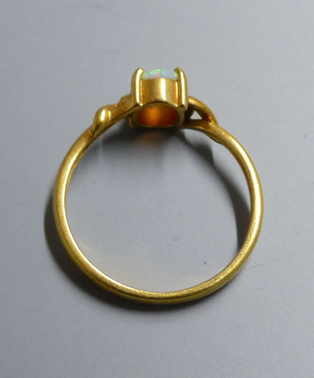An 18k and single stone white opal ring, size O, gross 2.5 grams.